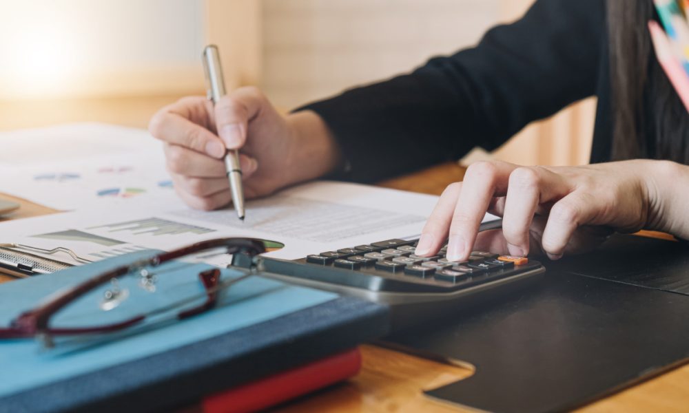 Accountant working with calculator for investigation of corruption account.